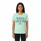 Mint green t-shirt with 'Boring Builds Wealth' text and pyramid graphic on a white background